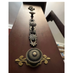 Brass knobs down the side of the clock